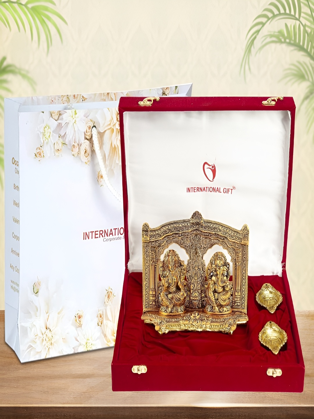 

INTERNATIONAL GIFT Gold-Toned Religious Figurine Showpiece With Diyas & Velvet Box