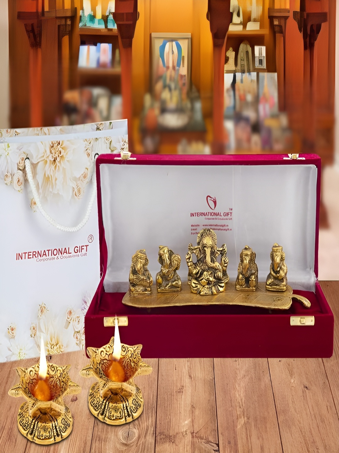 

INTERNATIONAL GIFT Gold-Toned Religious Figurine Showpiece With Diyas & Velvet Box