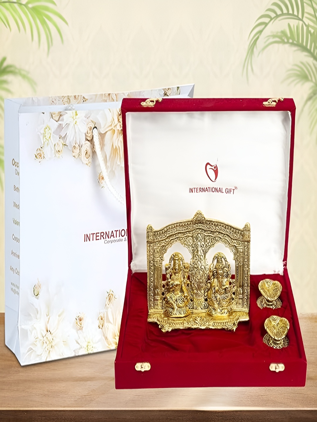 

INTERNATIONAL GIFT Gold-Toned Religious Figurine Showpiece With Diyas & Velvet Box