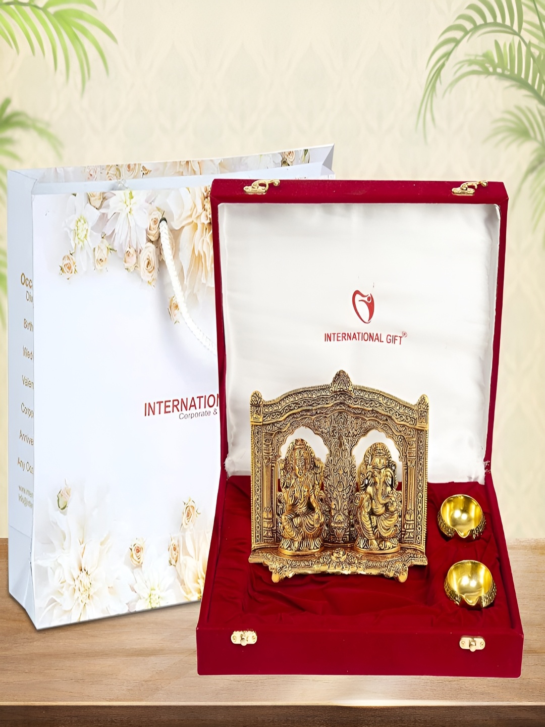 

INTERNATIONAL GIFT Gold-Toned Religious Figurine Showpiece With Diyas & Velvet Box
