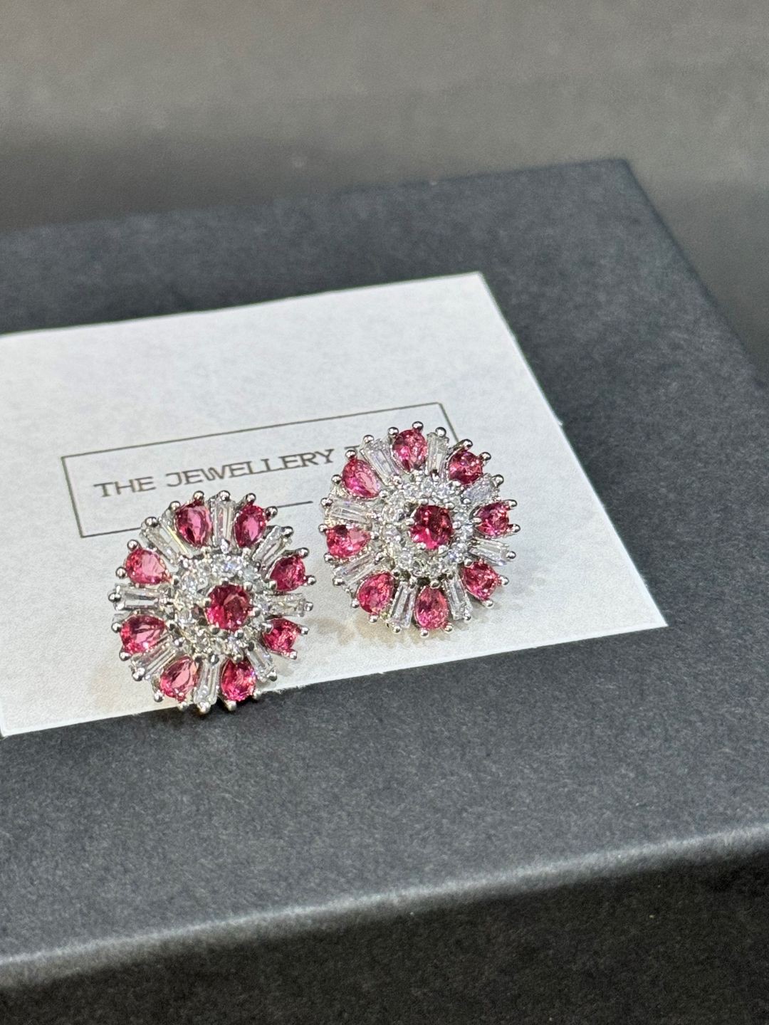 

The Jewellery Tale Rhodium Plated Emerald Floral Baguette Diamond And Ruby Studs, Silver