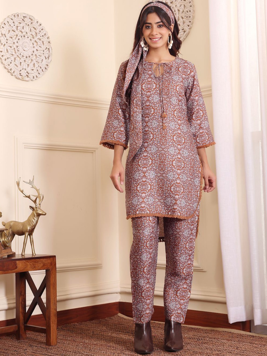 

Varanga Camel Brown Floral Printed Tie-up Neck Acrylic Tunic With Trousers