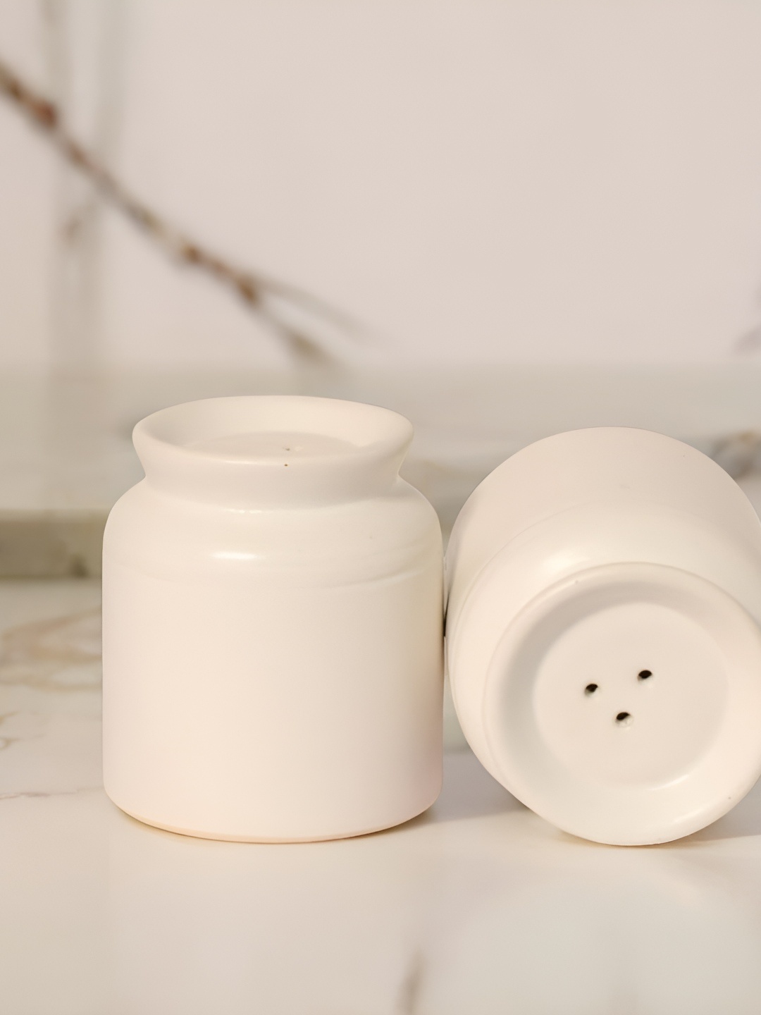 

The Decor Lane White Ceramic Salt and Pepper Shakers