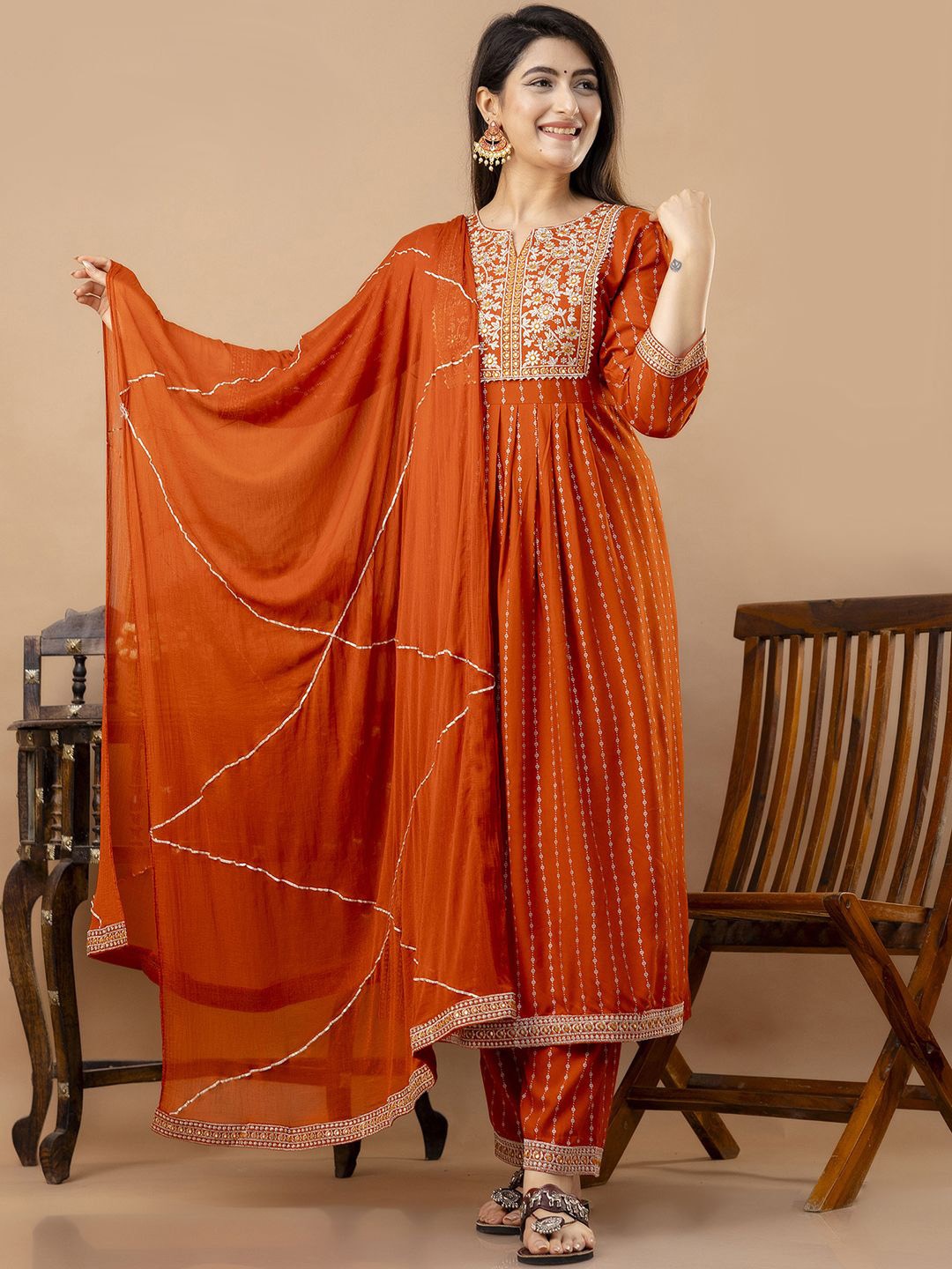 

Veshviti Women Floral Embroidered Pleated Mirror Work Kurta with Trousers & With Dupatta, Orange