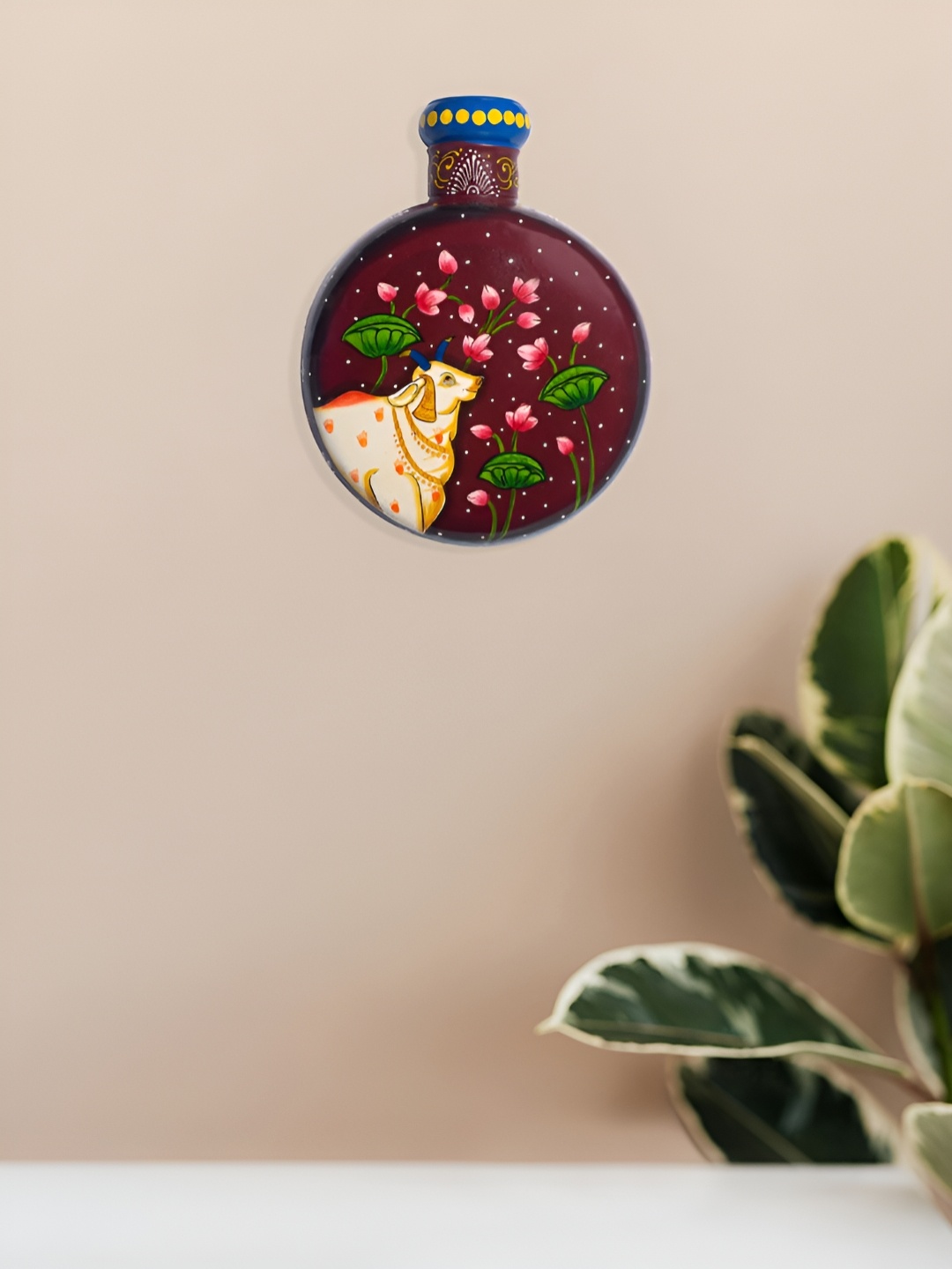 

Golden Peacock Maroon & Green Cow Printed Matka Shaped Hanging Wall Decor