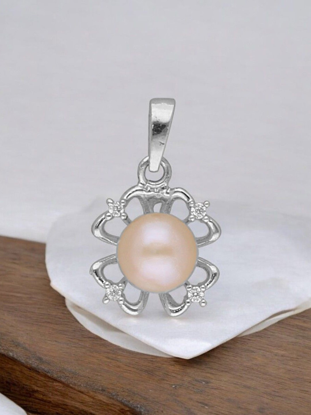 

Sri Jagdamba Pearls Dealer 92.5 Sterling Silver Floral Shaped Pendants