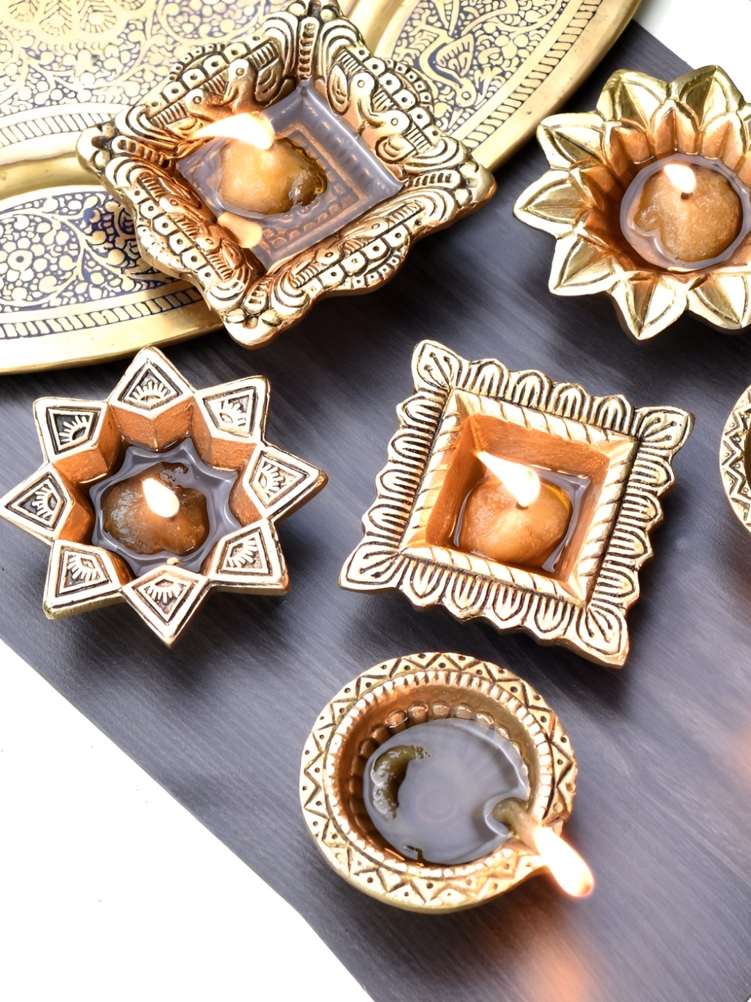 

Indianshelf Gold-Toned 6 Pieces Brass Textured Diya Pooja Essentials