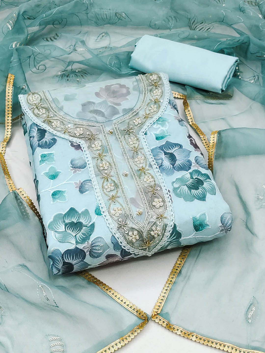 

Ishin Blue Floral Embroidered Beads and Stones Organza Unstitched Dress Material