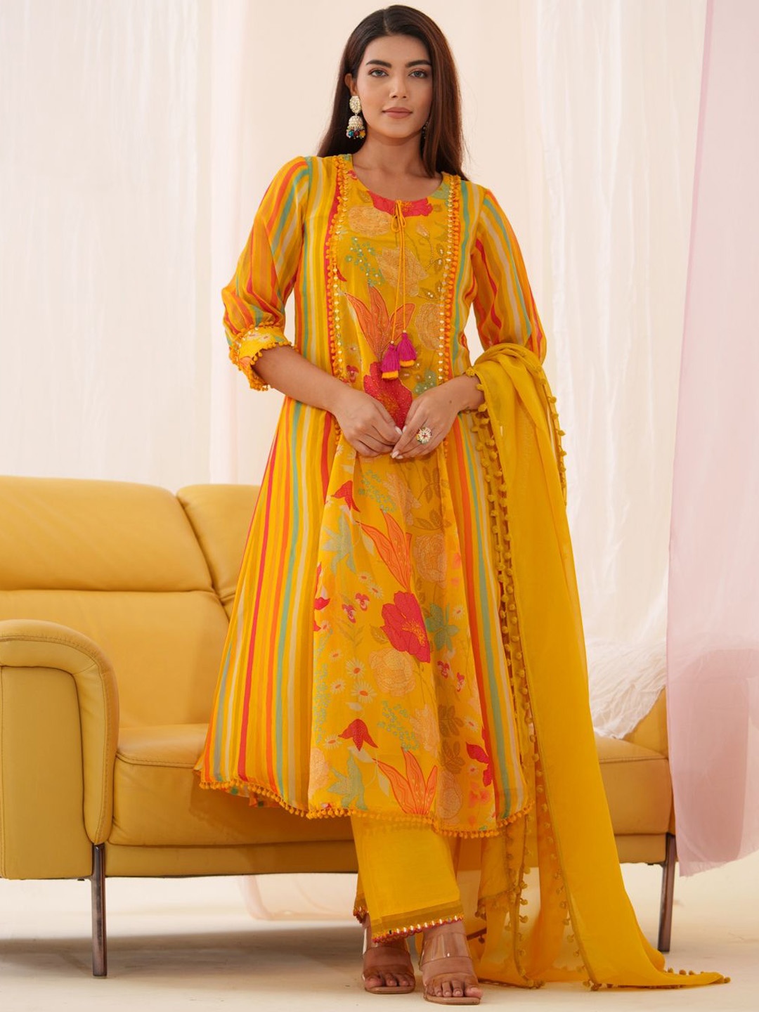 

Sangria Floral Printed Mirror Work Tie-Up Neck Organza Kurta With Trousers & Dupatta, Mustard