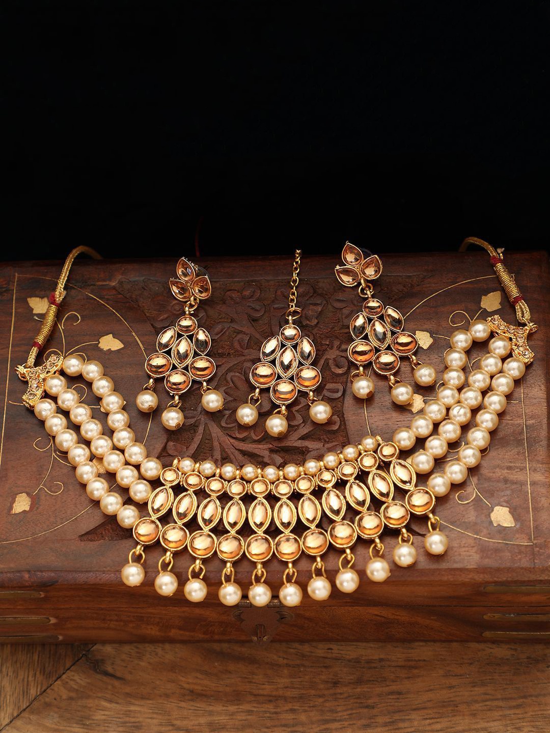 

Anouk Cream Gold Plated Kundan Stones Studded & Pearl Beaded Jewellery Set