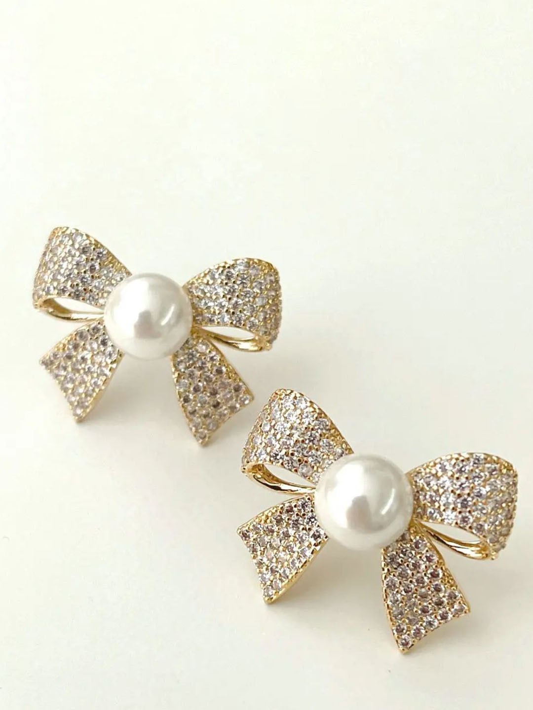 

Celestique Cubic Zirconia & Pearls Studded Bow Shaped Studs, Gold