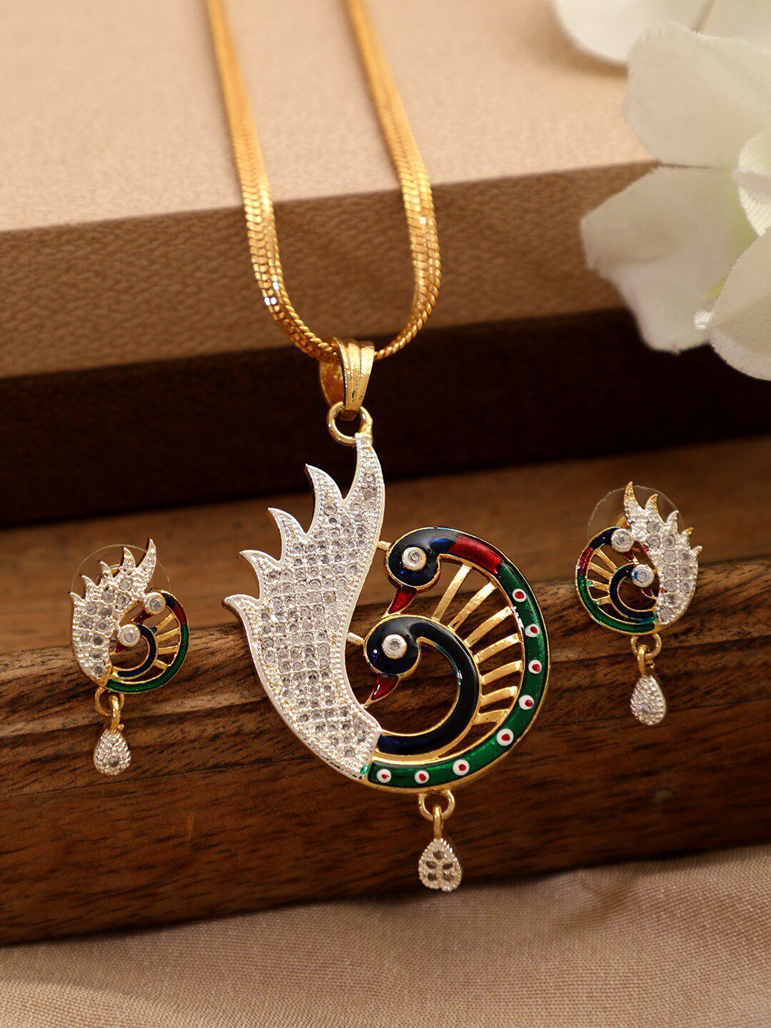 

Anouk Gold Plated American Diamond Studded Peacock Shaped Pendant and Earrings