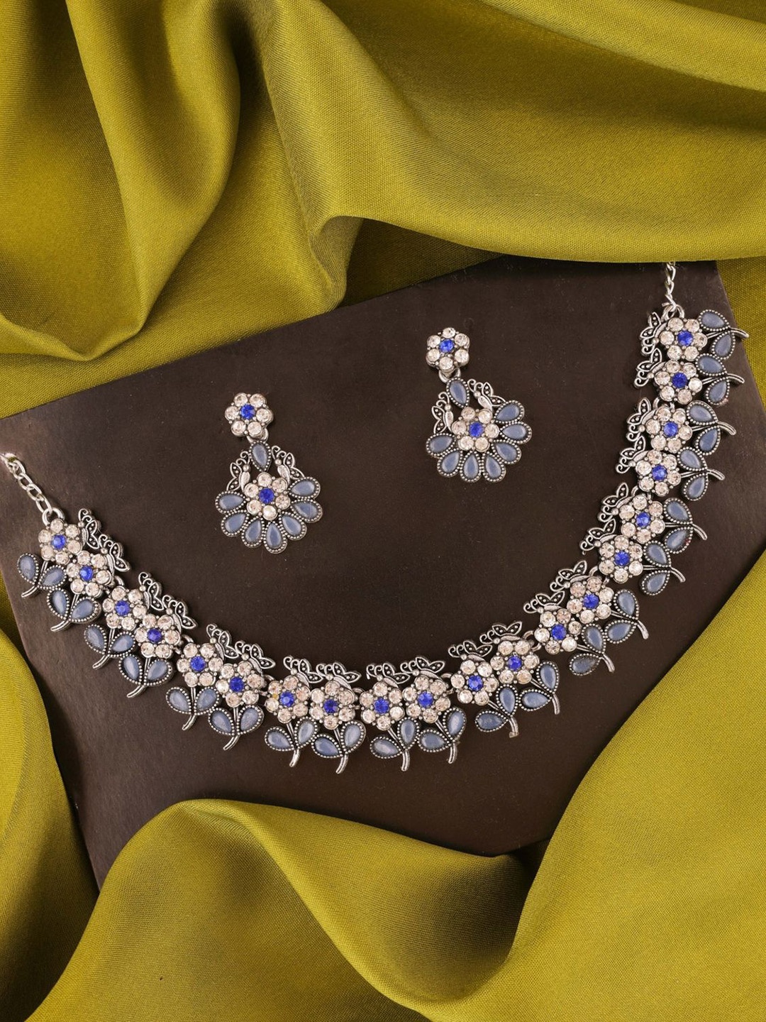 

Lyriss Silver-Plated American Diamond Studded Floral Shaped Jewellery Set