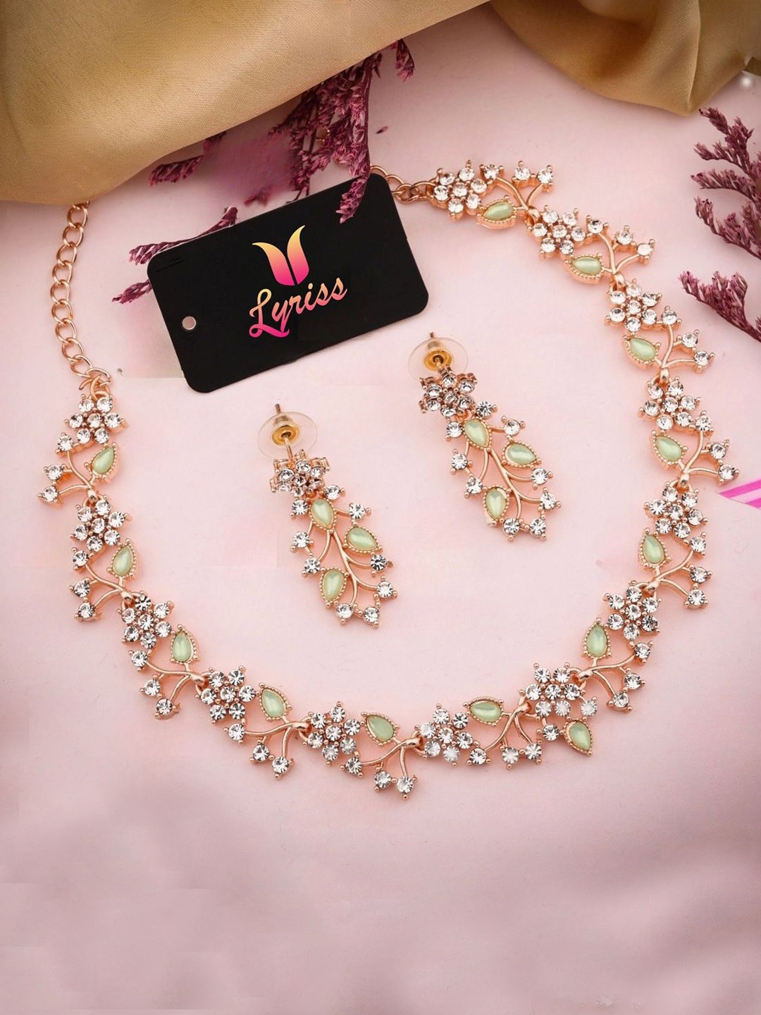

Lyriss Gold-Plated American Diamond Studded Floral Shaped Jewellery Set