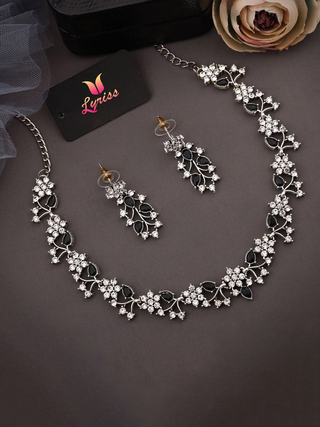 

Lyriss Silver-Plated American Diamond Studded Floral Shaped Jewellery Set