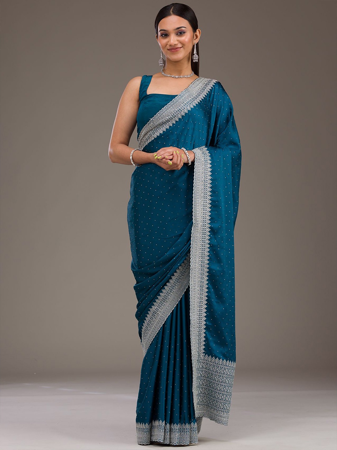 

Koskii Peacock Blue Stonework Satin Saree