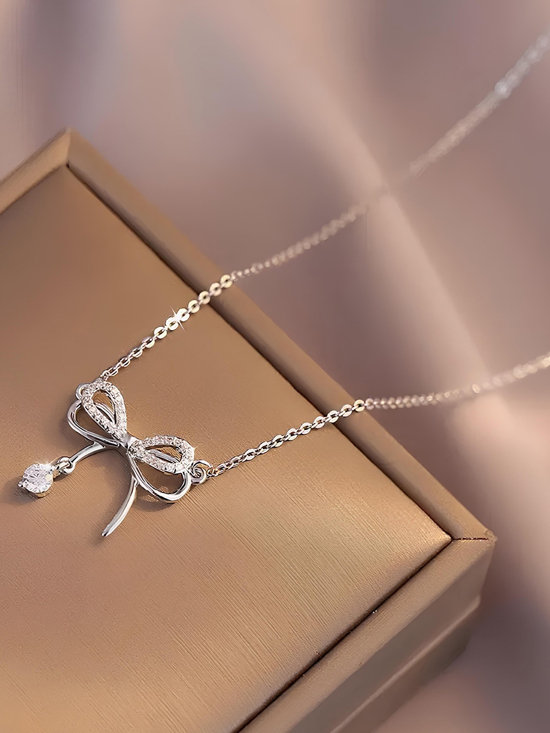 

KARISHMA KREATIONS Stainless Steel Silver-Plated CZ Bowknot Contemporary Pendant