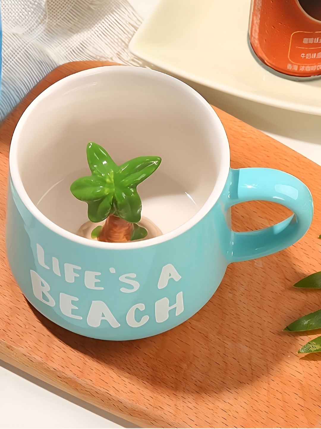 

BonZeaL Blue & White Printed Ceramic Glossy Mug With Palm Tree Inside Figurine-350 ml