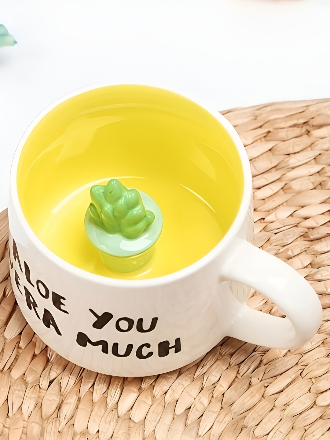 

BonZeaL White & Yellow Printed Ceramic Glossy Mug With Aloevera Inside Figurine-350 ml