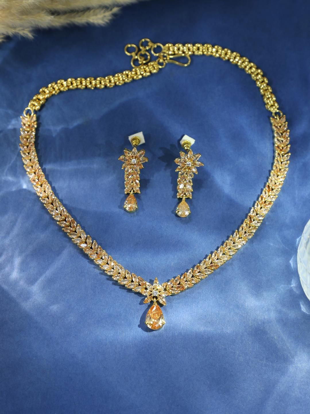 

ANIKAS CREATION Rose Gold Plated American Diamond Studded Necklace With Earrings