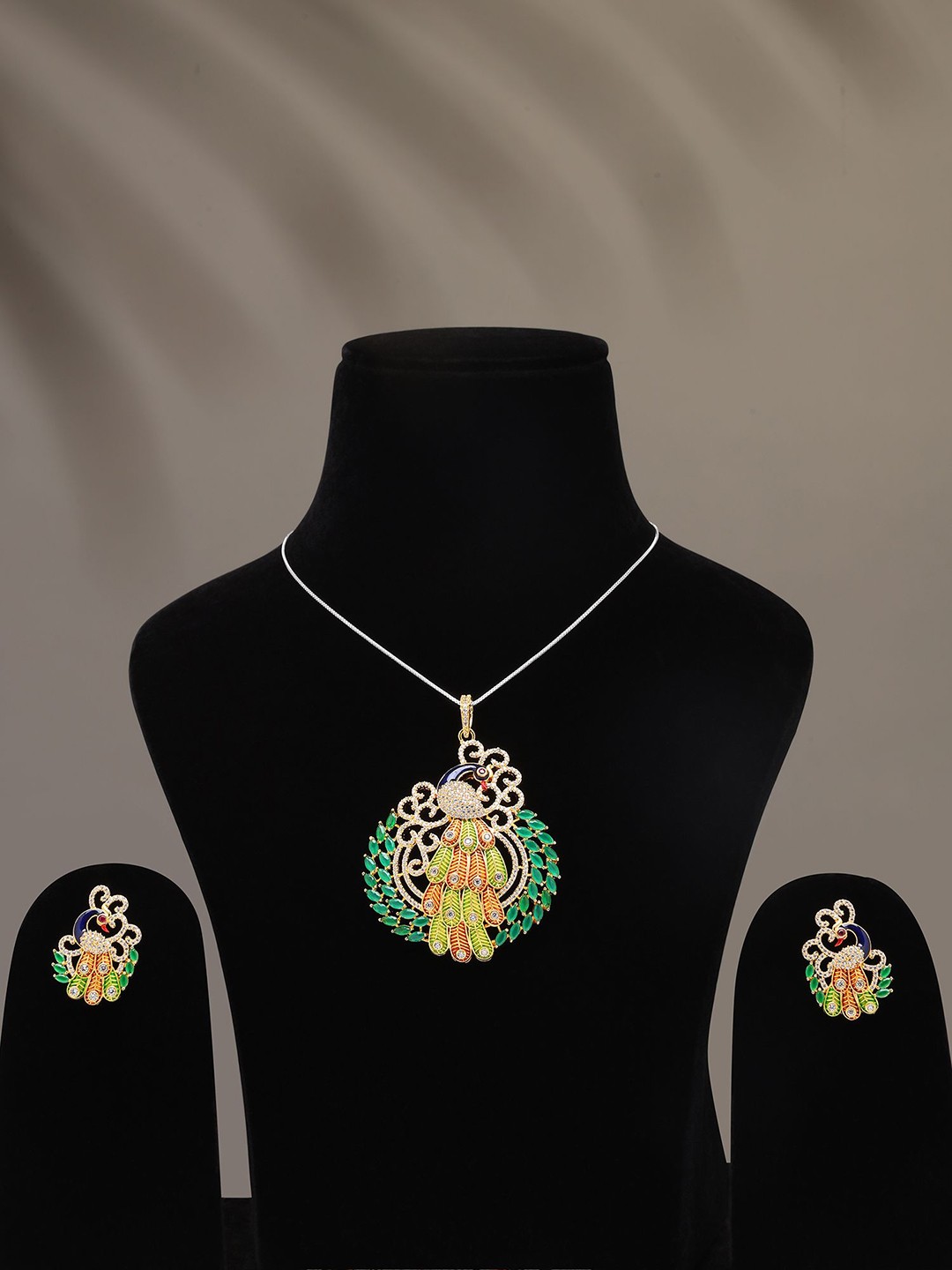 

Exotic India Designer Peacock Pendant & Earrings Set With Cubic Zirconia, Gold