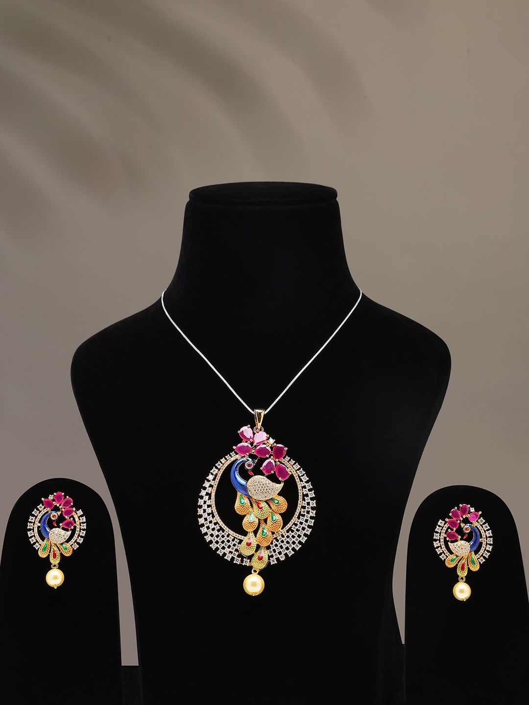 

Exotic India Multicolor Stone Studded Peacock Pendant & Earrings Set With Pearl Drop, Gold