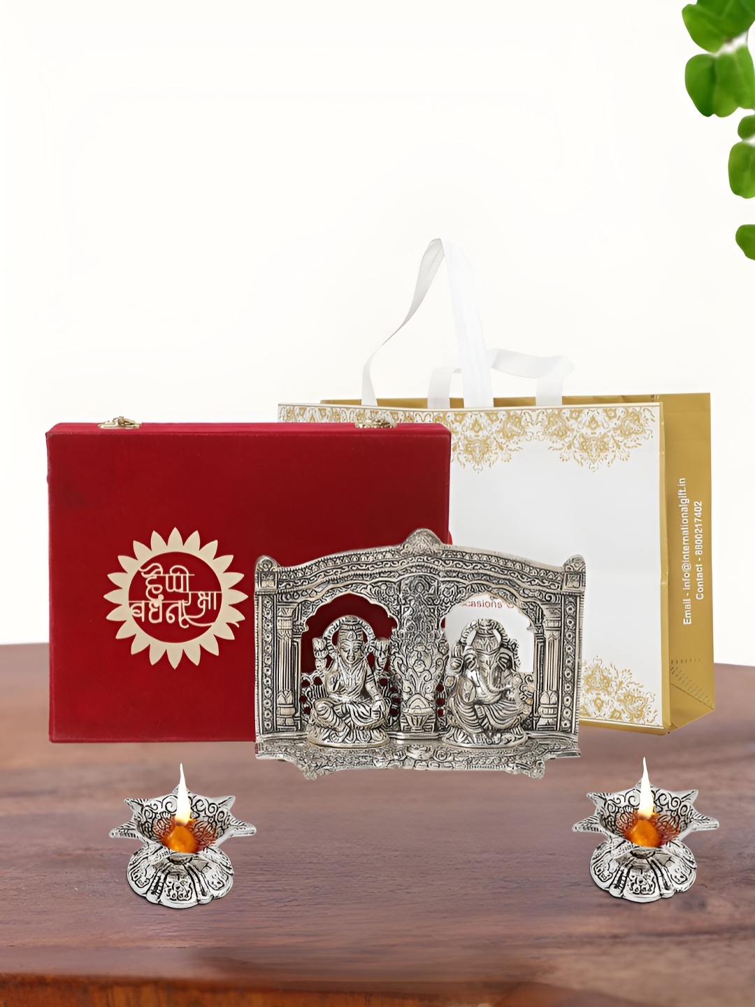 

INTERNATIONAL GIFT Silver Plated Laxmi Ganesh Idol with 2 Diya Box and Bag