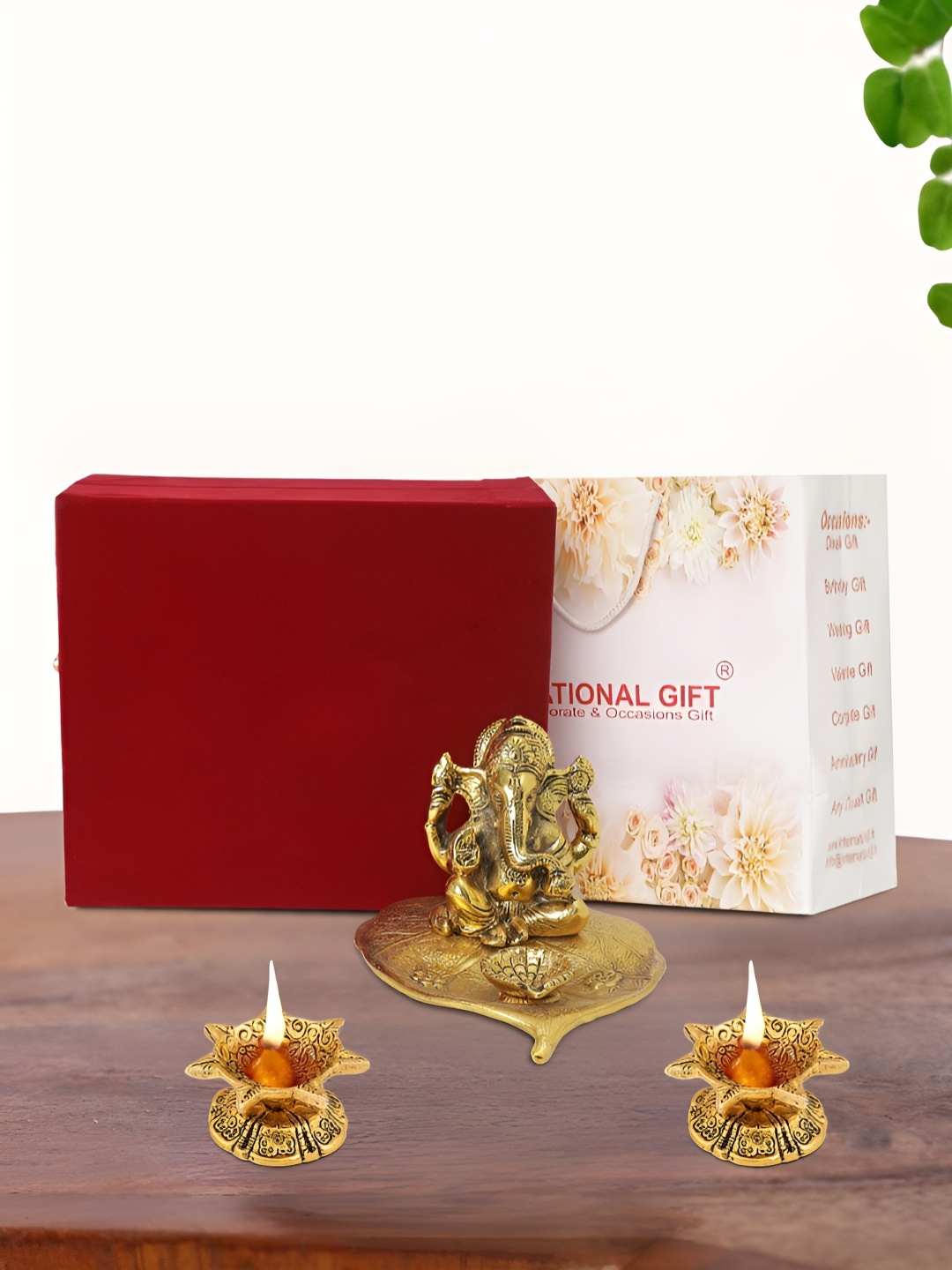 

INTERNATIONAL GIFT Gold Plated Leaf Ganesh Idol with 2 Diya Box and Bag