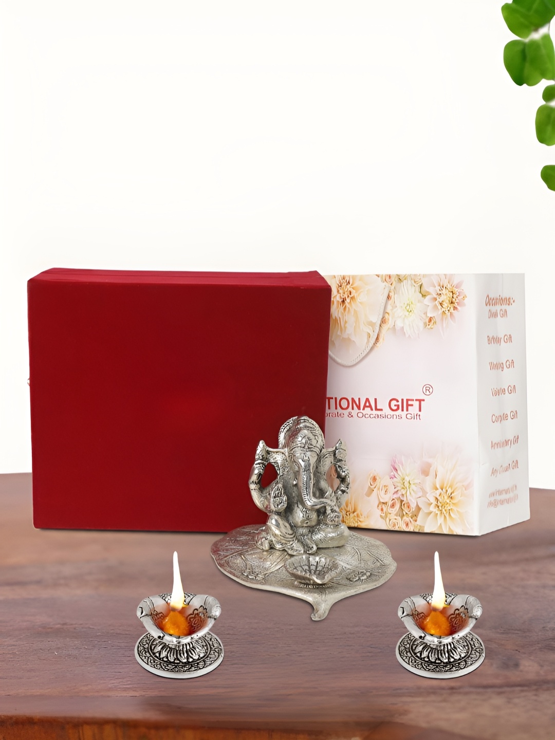 

INTERNATIONAL GIFT Silver Plated Leaf Ganesh Idol with 2 Diya Box and Bag