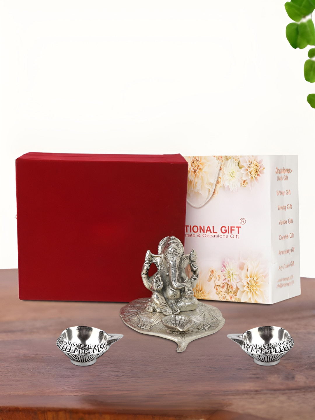 

INTERNATIONAL GIFT Silver Plated Leaf Ganesh Idol with 2 Diya Box and Bag