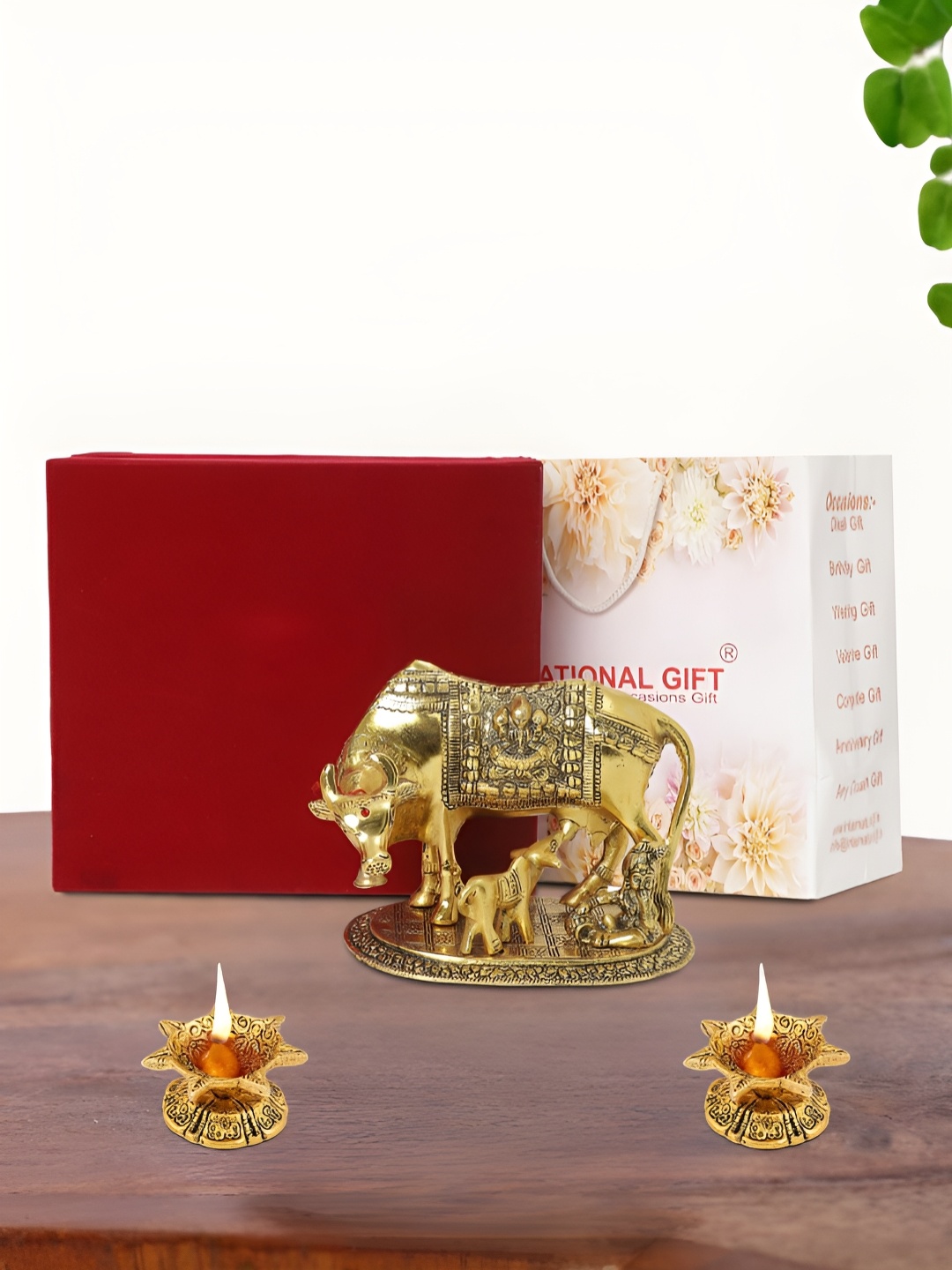 

INTERNATIONAL GIFT Gold Plated Kamdhenu Cow with 2 Diya and Box