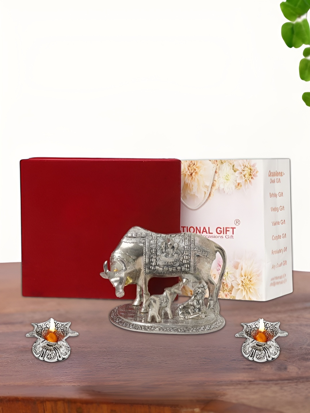 

INTERNATIONAL GIFT Silver Plated Kamdhenu Cow with 2 Diya Box and Bag