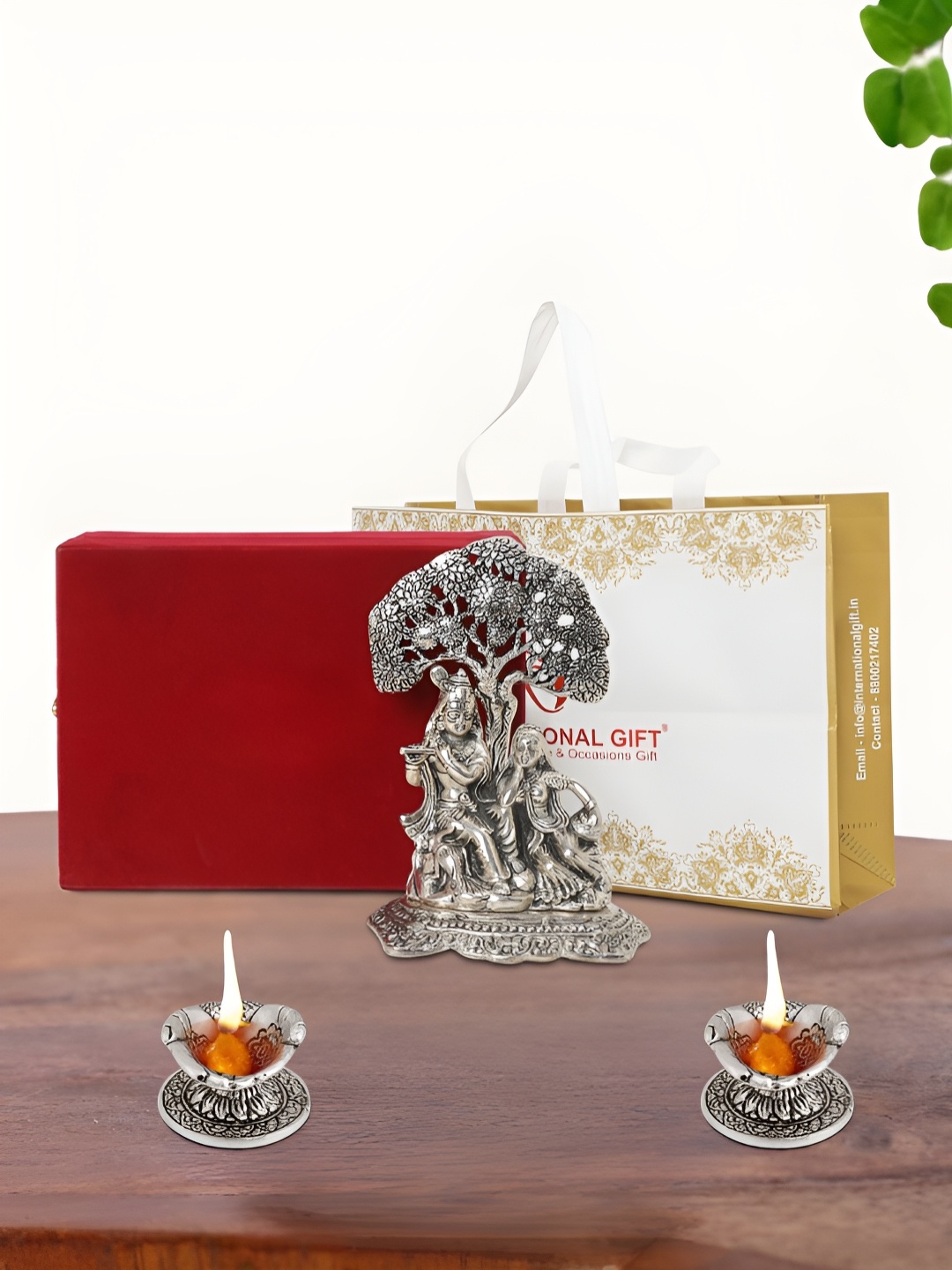 

INTERNATIONAL GIFT Silver Plated Radha Krishna Idol with 2 Diya Box and Bag