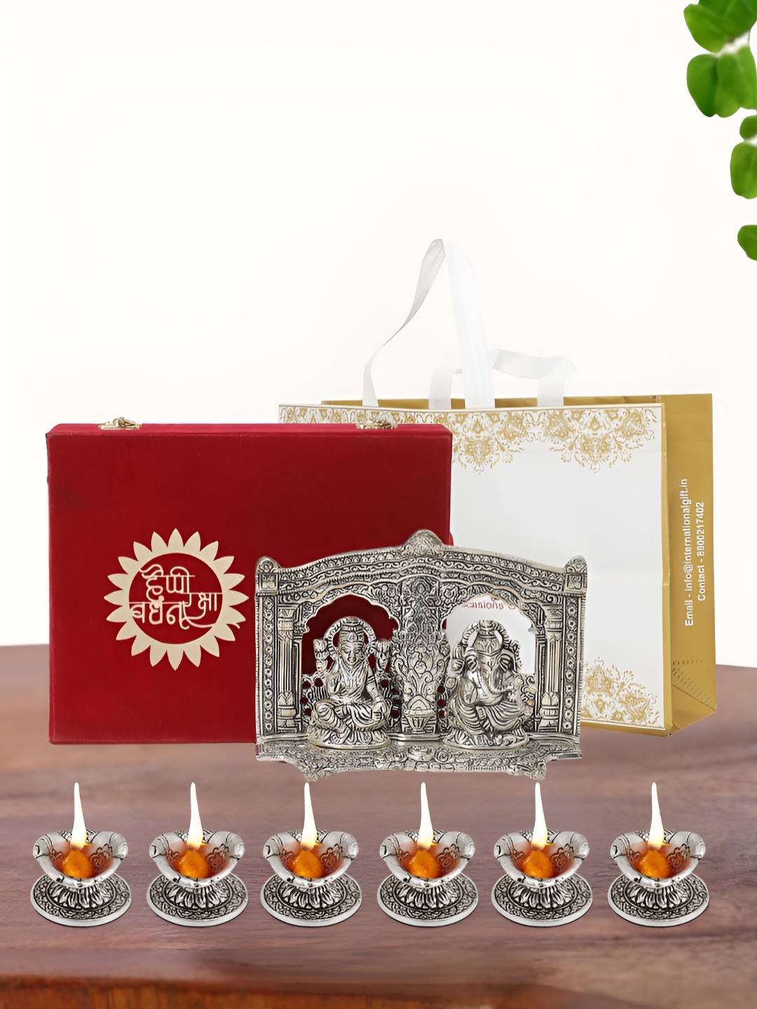 

INTERNATIONAL GIFT Silver Plated Laxmi Ganesh Idol with 6 Diya Box and Bag
