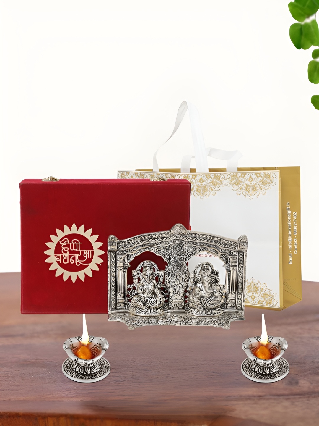 

INTERNATIONAL GIFT Silver Plated Laxmi Ganesh Idol with 2 Diya Box and Bag