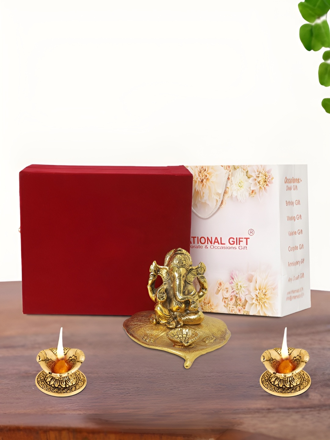 

INTERNATIONAL GIFT Gold Plated Leaf Ganesh Idol with 2 Diya Box and Bag