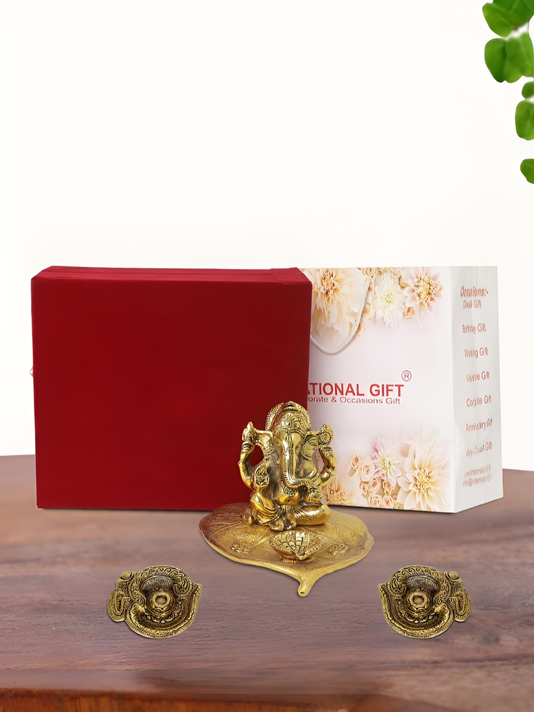 

INTERNATIONAL GIFT Gold Plated Leaf Ganesh Idol with 2 Diya Box and Bag