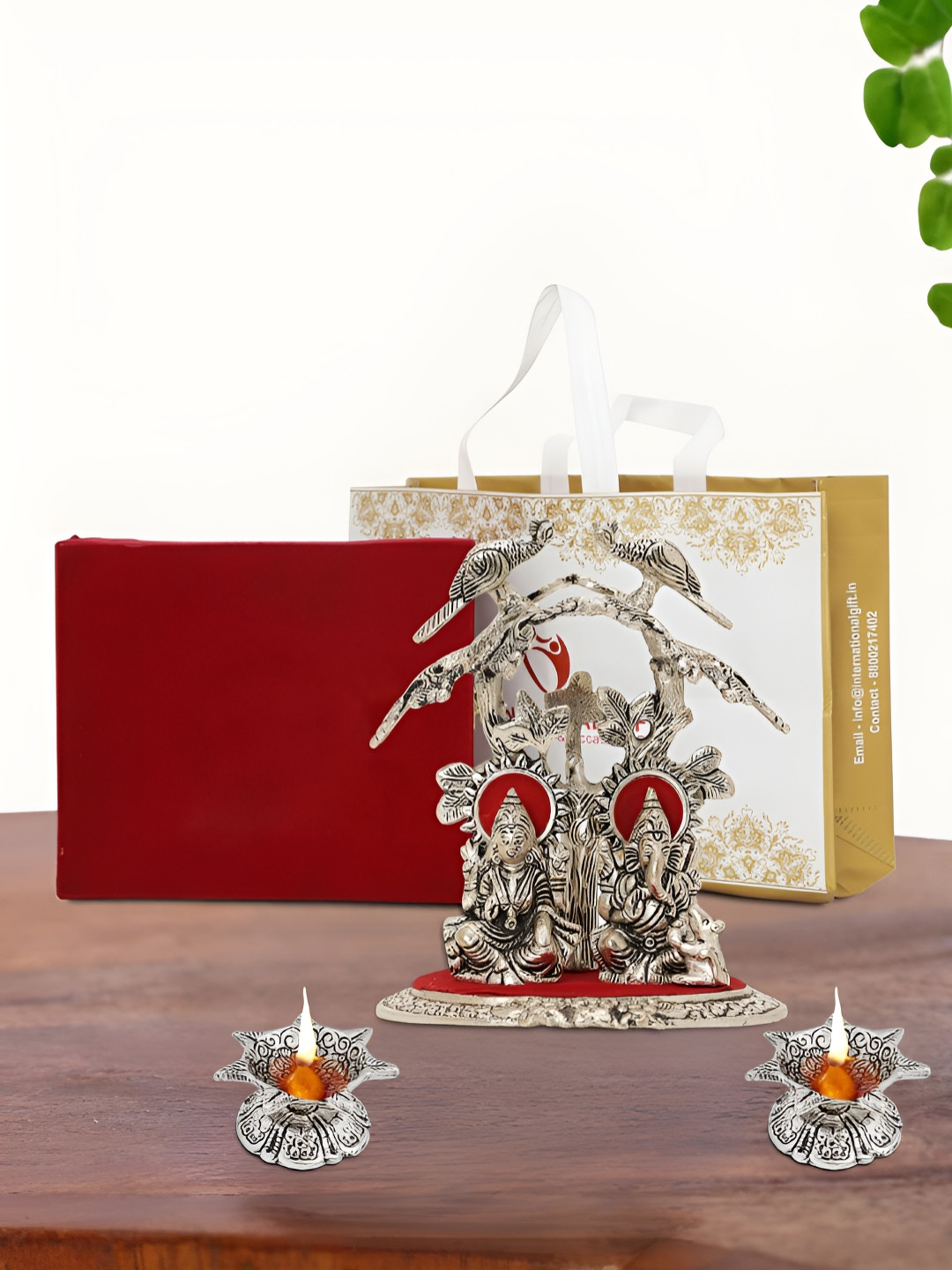 

INTERNATIONAL GIFT Silver Plated Laxmi Ganesh Idol with 2 Diya Box and Bag