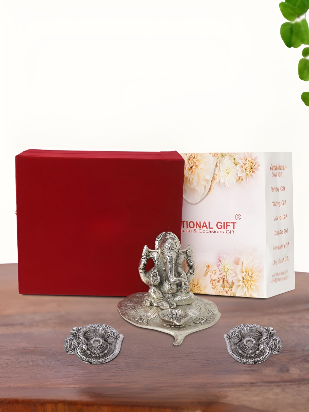 

INTERNATIONAL GIFT Silver Plated Leaf Ganesh Idol with 2 Diya Box and Bag