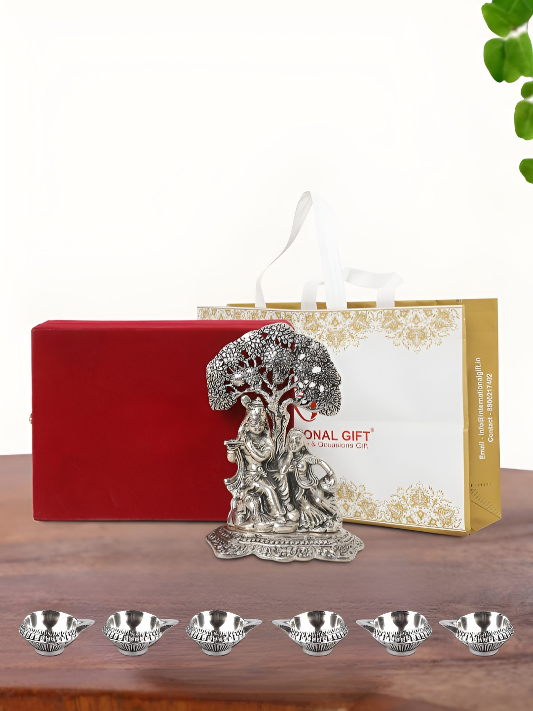 

INTERNATIONAL GIFT Silver Plated Radha Krishna Idol with 6 Diya Box and Bag
