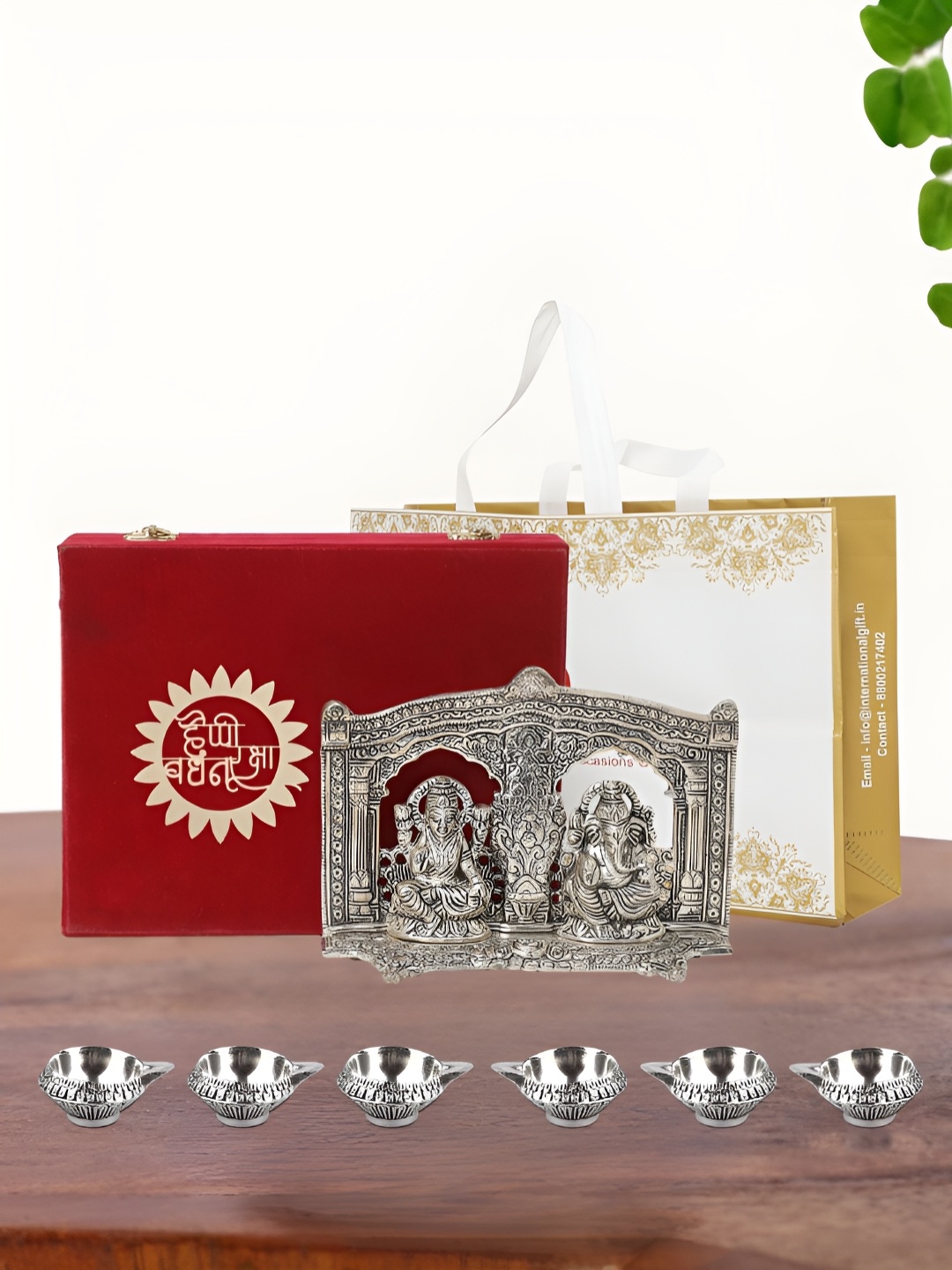 

INTERNATIONAL GIFT Silver Plated Laxmi Ganesh Idol with 6 Diya Box and Bag