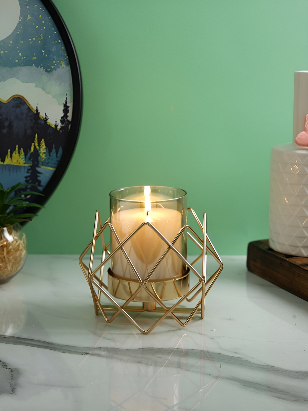 

Myntra Elegant Homes Gold-Toned & Transparent Geometric Candle Holder