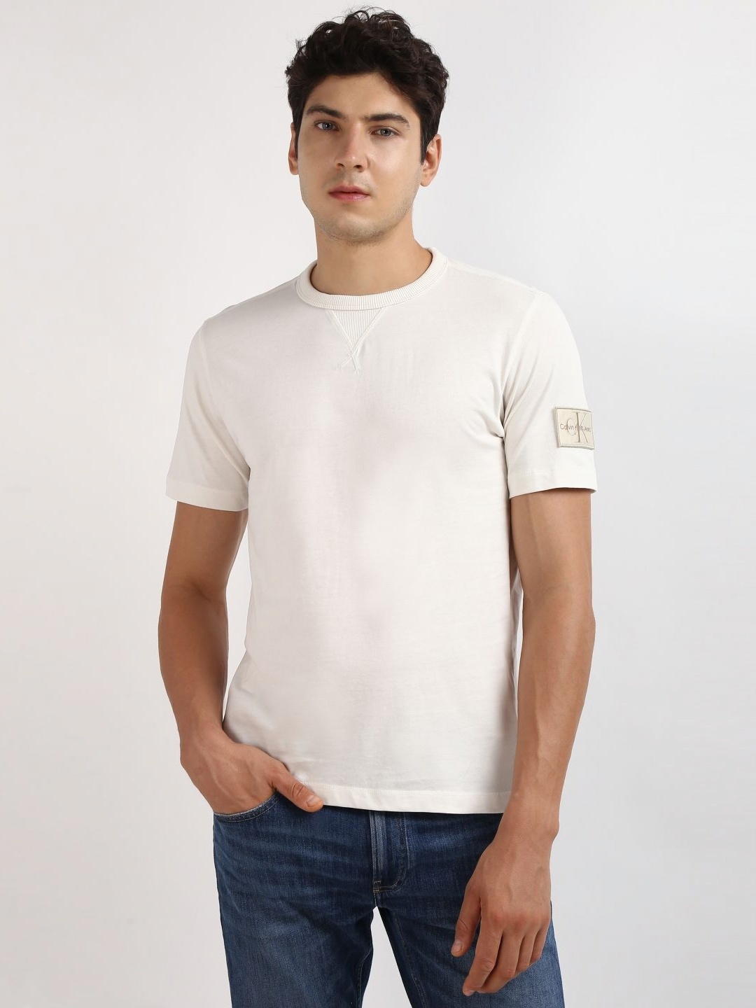 

Calvin Klein Jeans Men Solid Round Neck Applique Cotton T-shirt, Beige