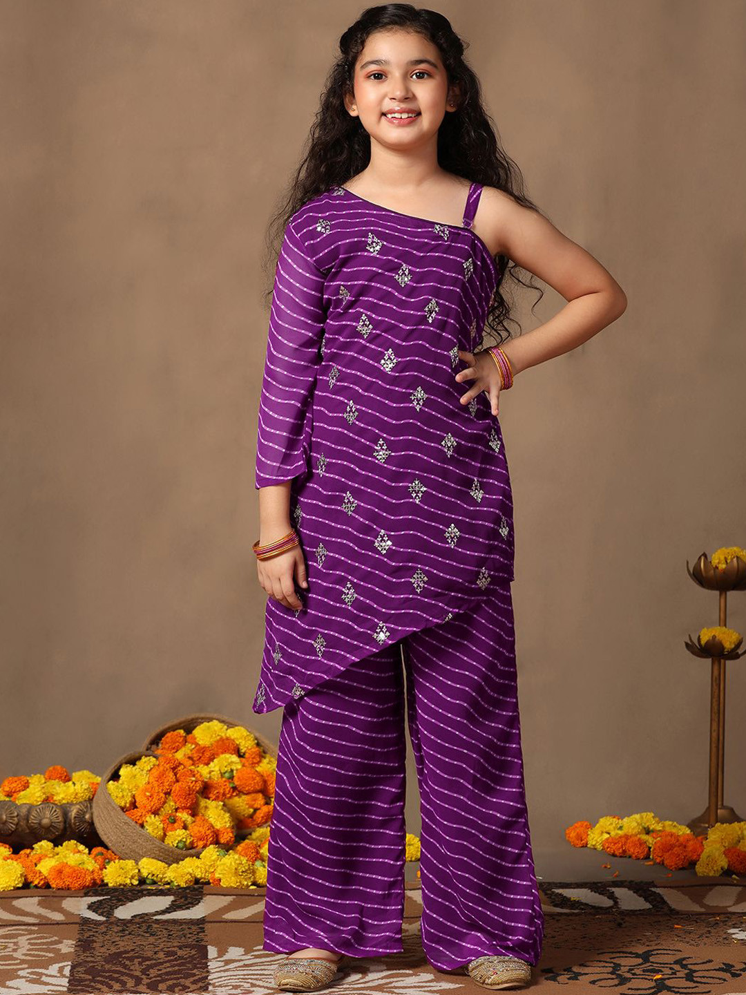

Sangria Girls Purple Leheriya Printed One Shoulder Georgette Straight Kurta & Palazzos