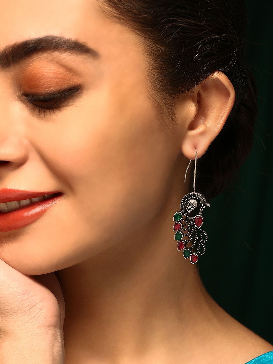 

Priyaasi Silver-Plated Artificial Stones Oxidized Peacock Shaped Drop Earrings