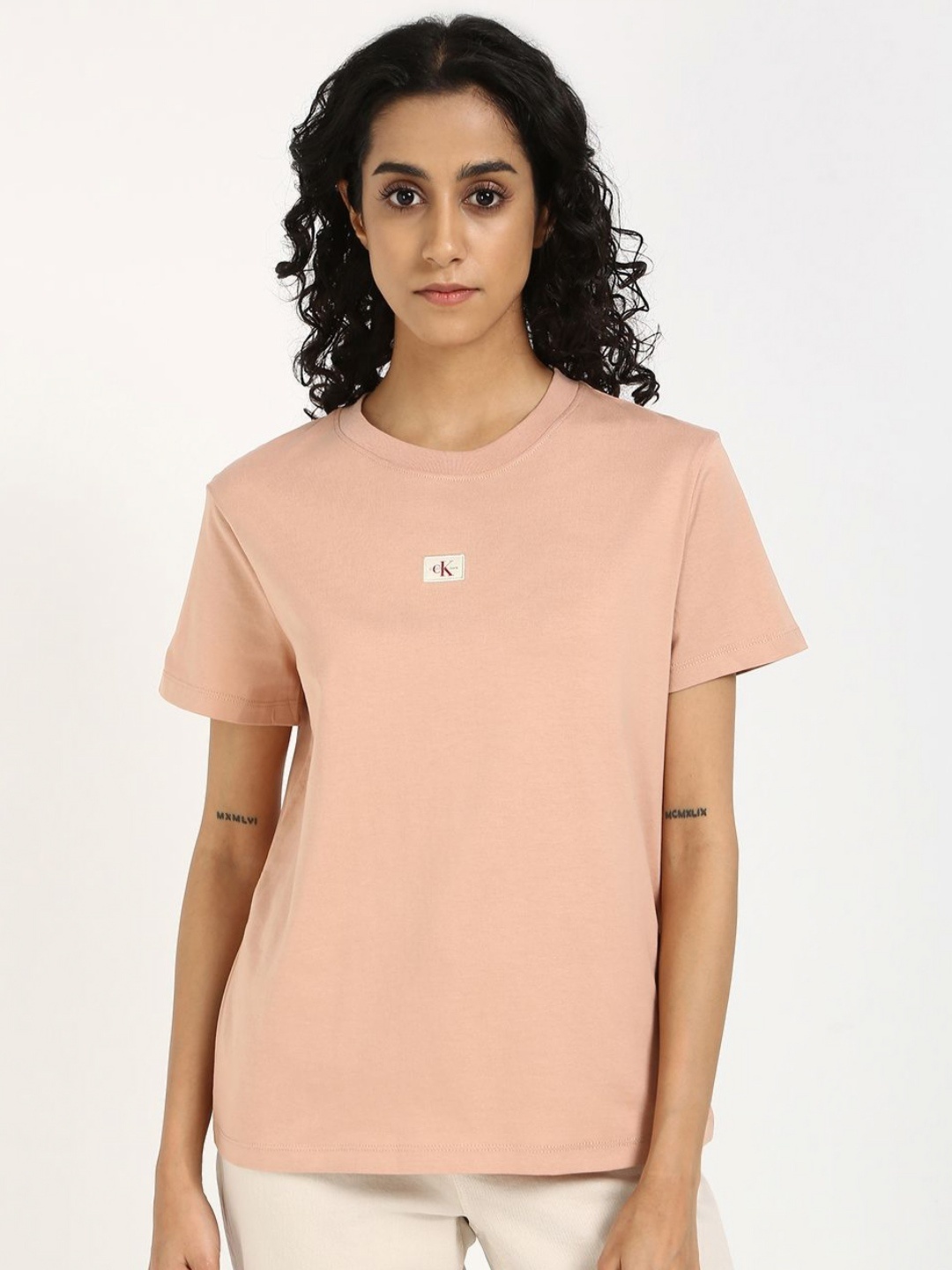 

Calvin Klein Jeans Women Solid Round Neck Cotton T-shirt, Peach