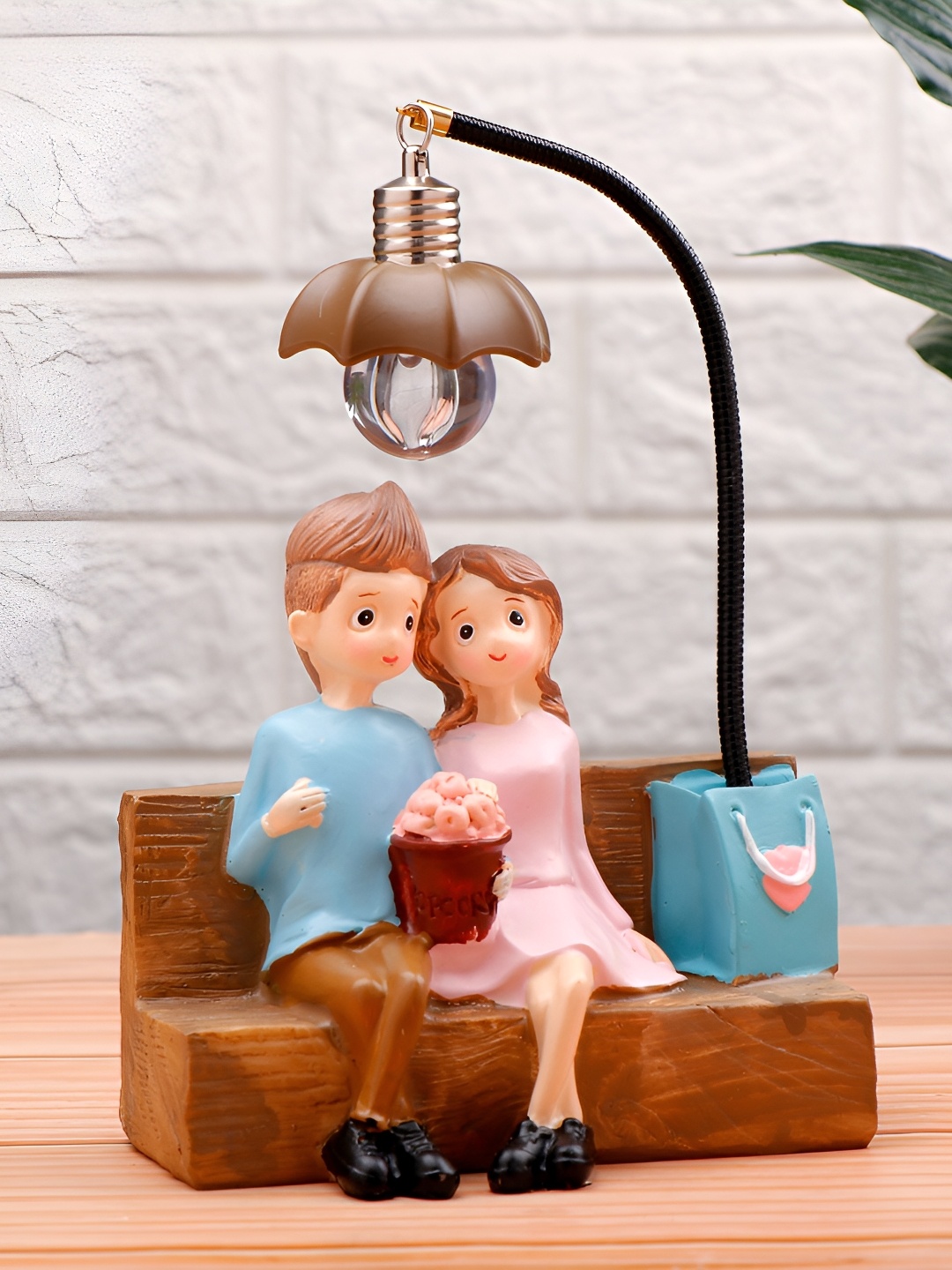

Archies Brown And Pink Couch Couple Illuminating Figurine Showpiece