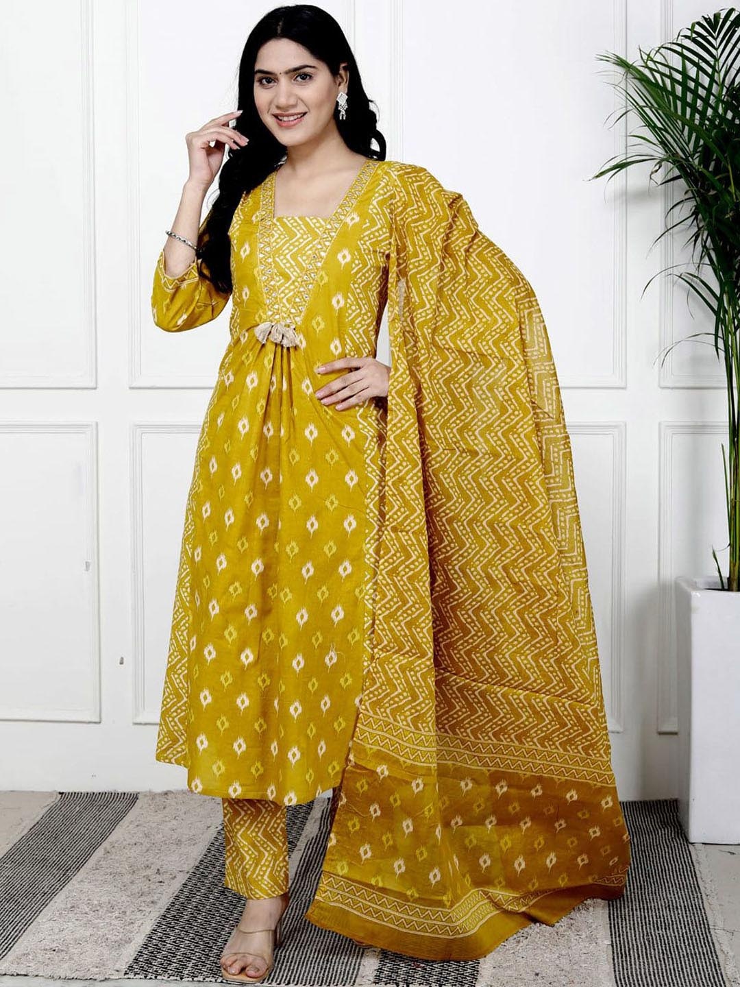 

Meena Bazaar Women Printed Regular Kurta with Trousers & With Dupatta, Mustard