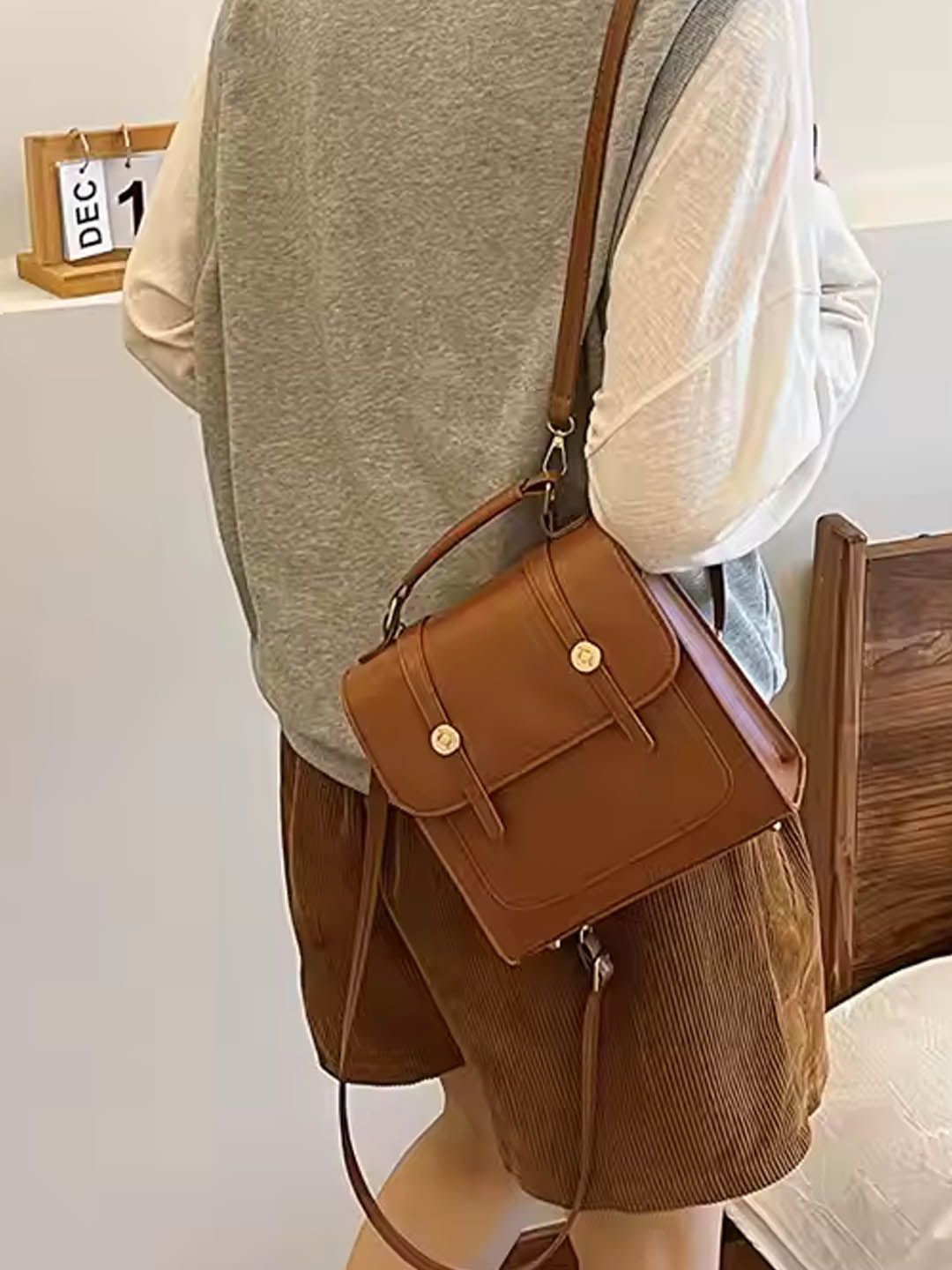 

StyleCast Textured Half Moon Handheld Bag with Tasselled, Brown