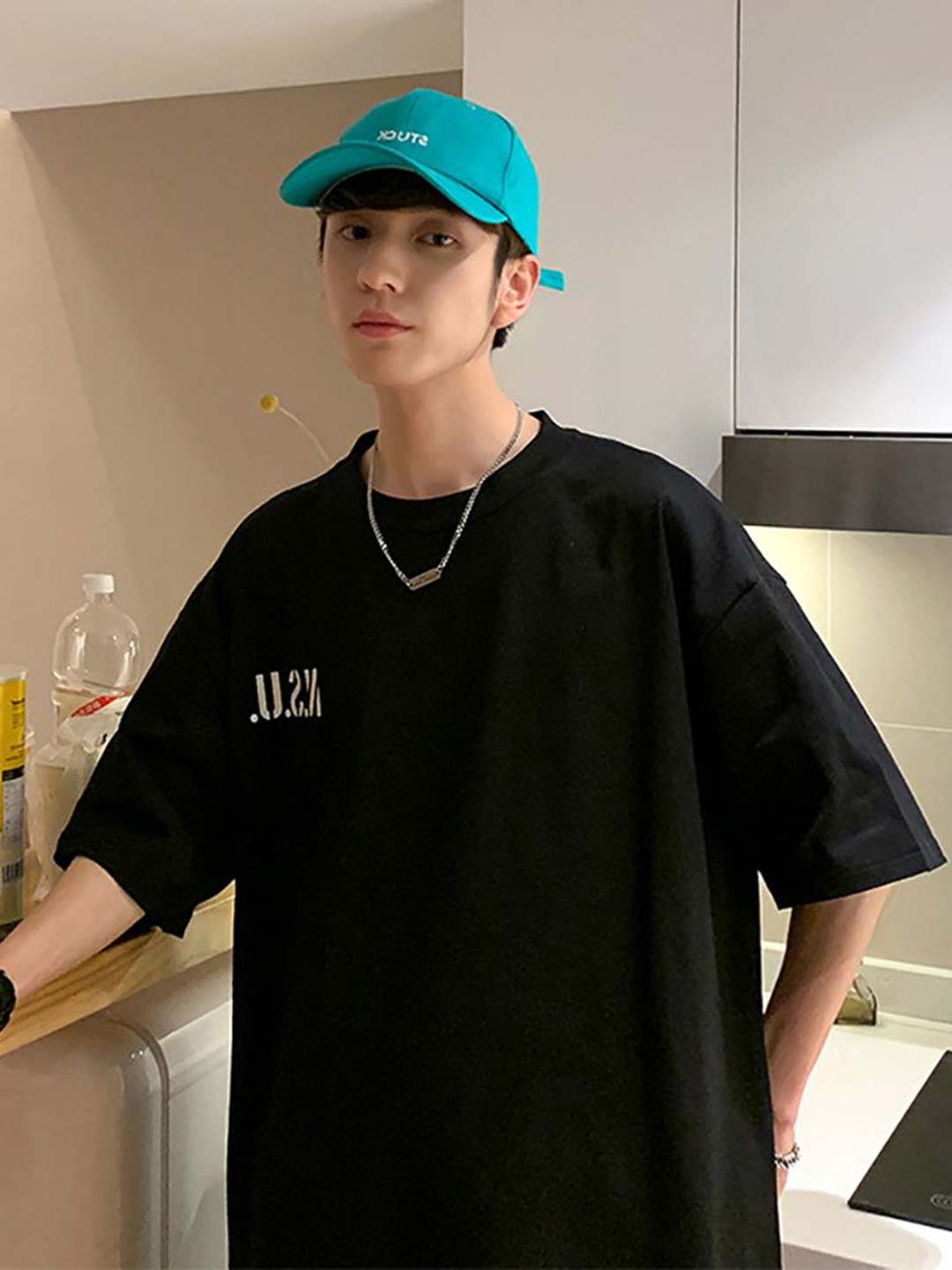 

StyleCast x Revolte Men Typography Printed Round Neck Oversized T-shirt, Black